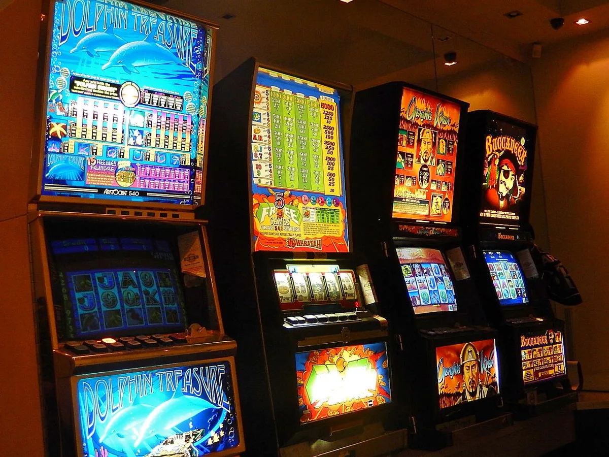 A row of Dolphin Treasure pokie machines in an Australian club