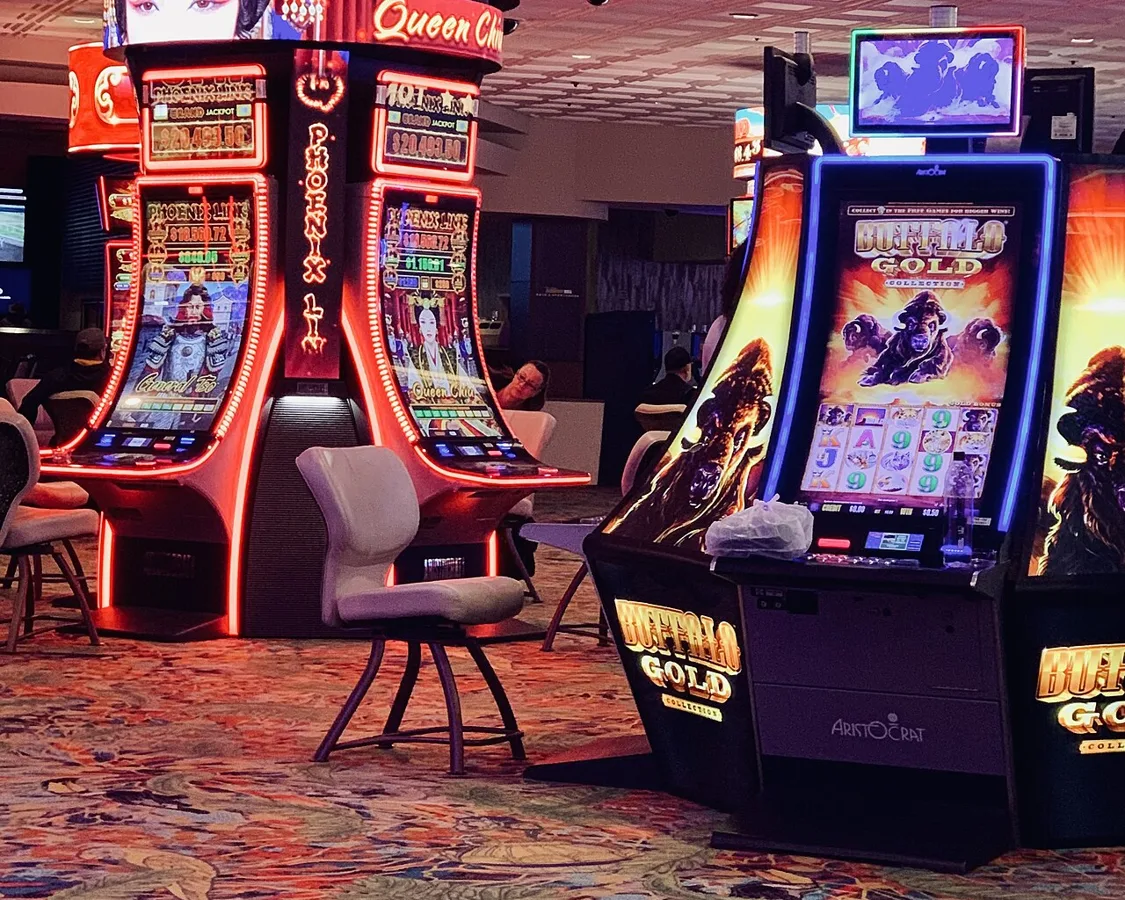 Rows of modern link-style pokie cabinets on a gaming floor